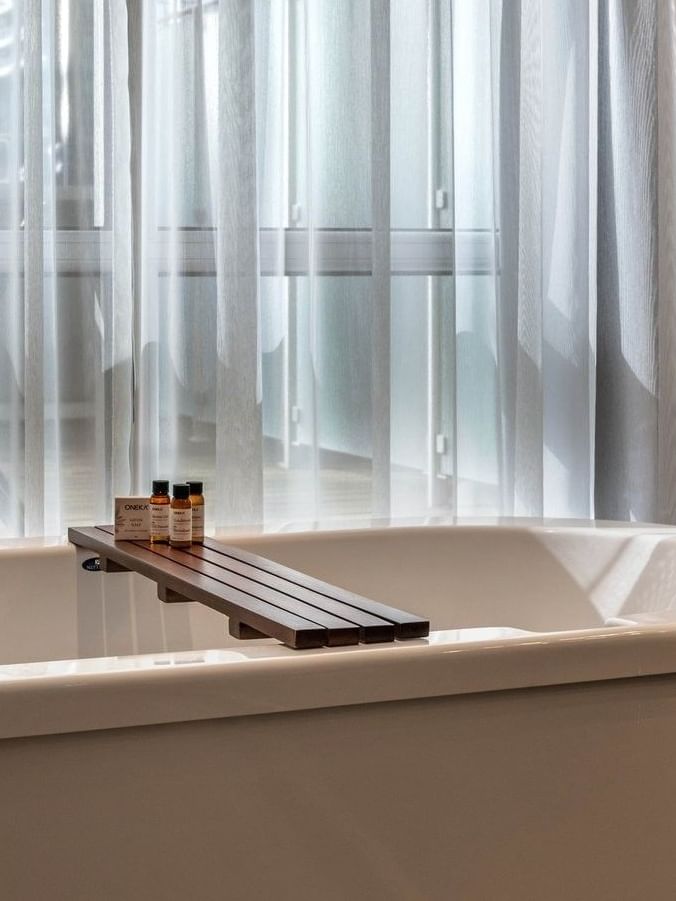 Elegant bathroom with bathtub and toiletries at Warwick Le Crystal – Montreal.