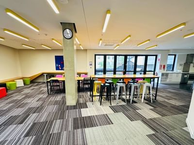 Long tables with chairs and stools at UniLodge Auckland City.