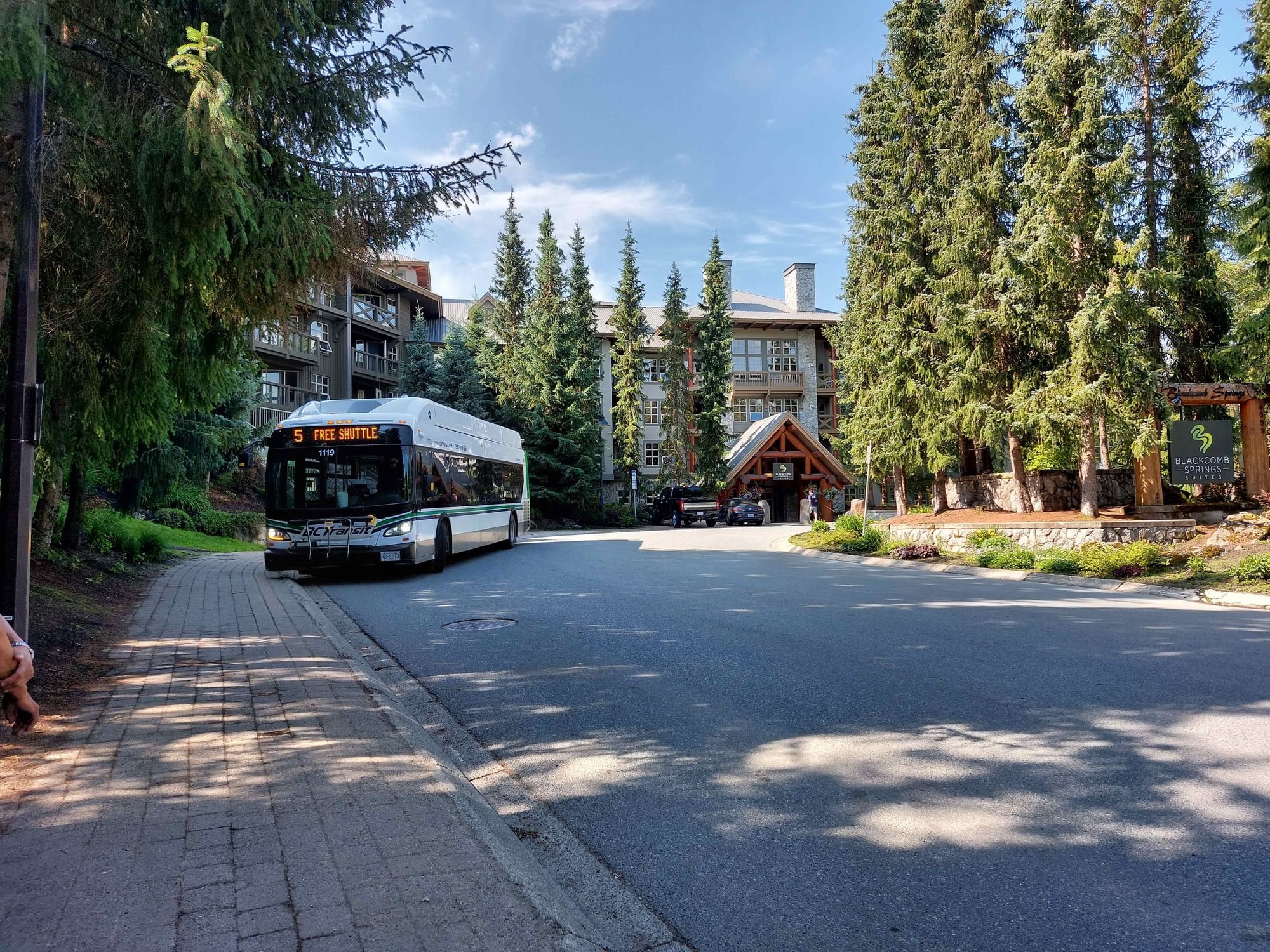 A Courtesy Shuttle parked by the front entrance of Blackcomb Springs Suites