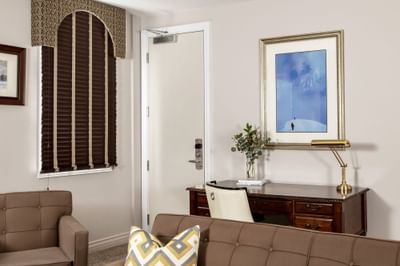 Lounge area with cozy sofa & workspace in Executive Residences 201 at Retro Suites Hotel