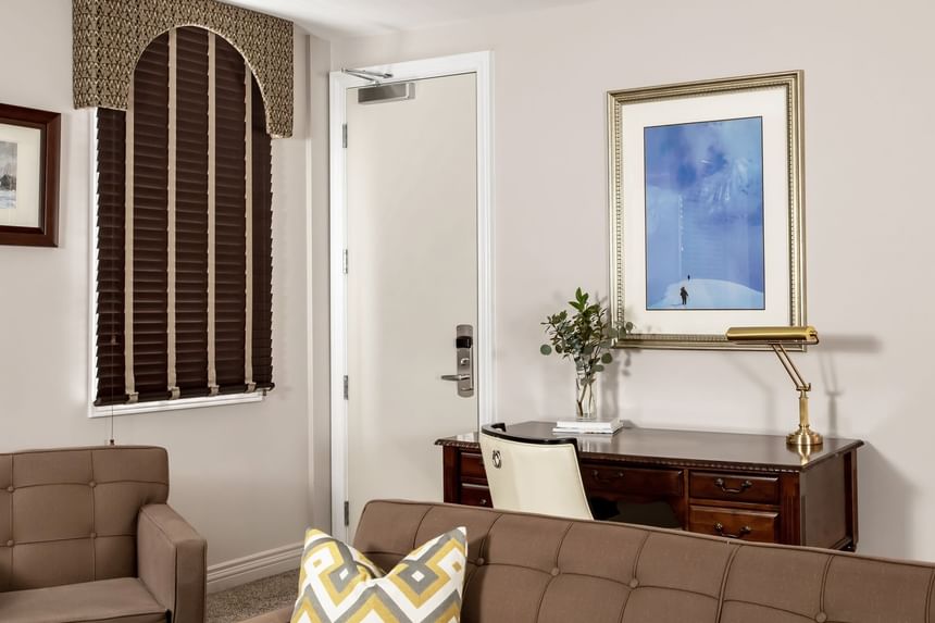 Lounge area with cozy sofa & workspace in Executive Residences 201 at Retro Suites Hotel