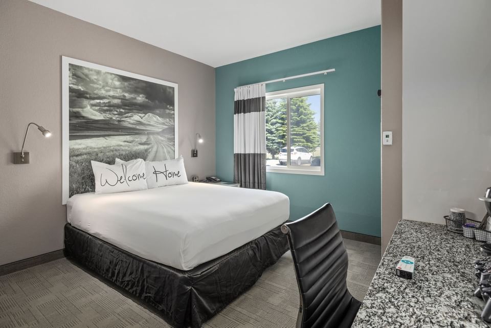 King-size bed, work desk in a Room at Home Hotels