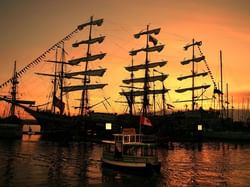 Tall ships docked at sunset in British Columbia's Maritime Museum near Huntingdon Manor