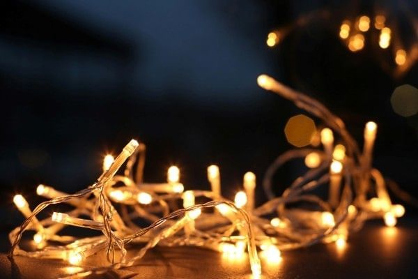 A string of twinkling lights sitting on a table in a dark room.