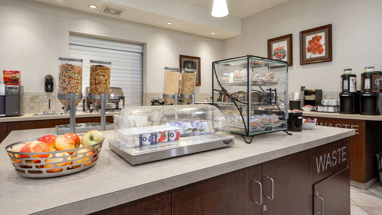 Hotel breakfast room with yogurt, pastries, fruit and cereals