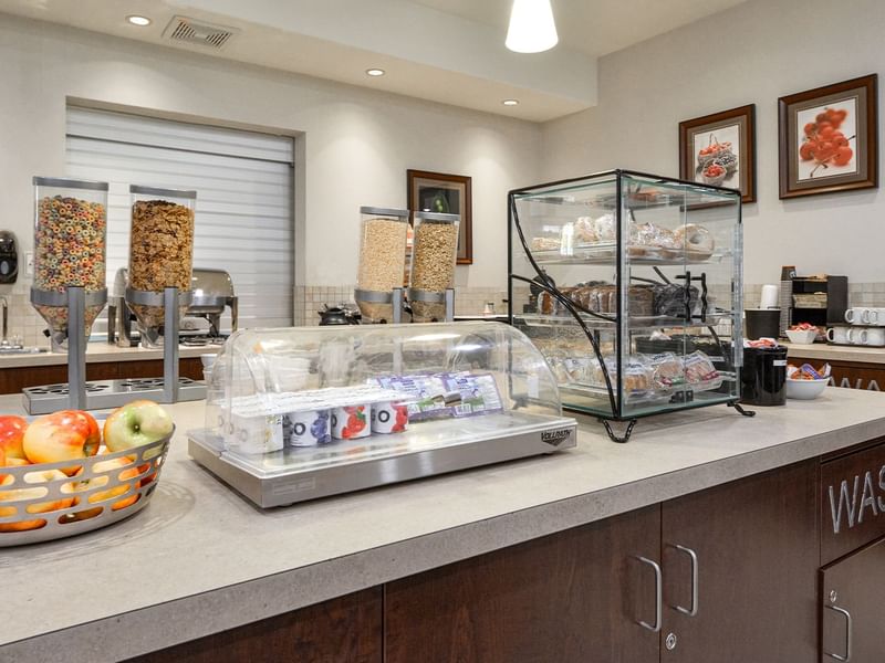 Hotel breakfast room with yogurt, pastries, fruit and cereals