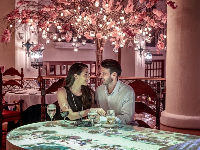 Dining couple looking at each other at Grand Fiesta Americana