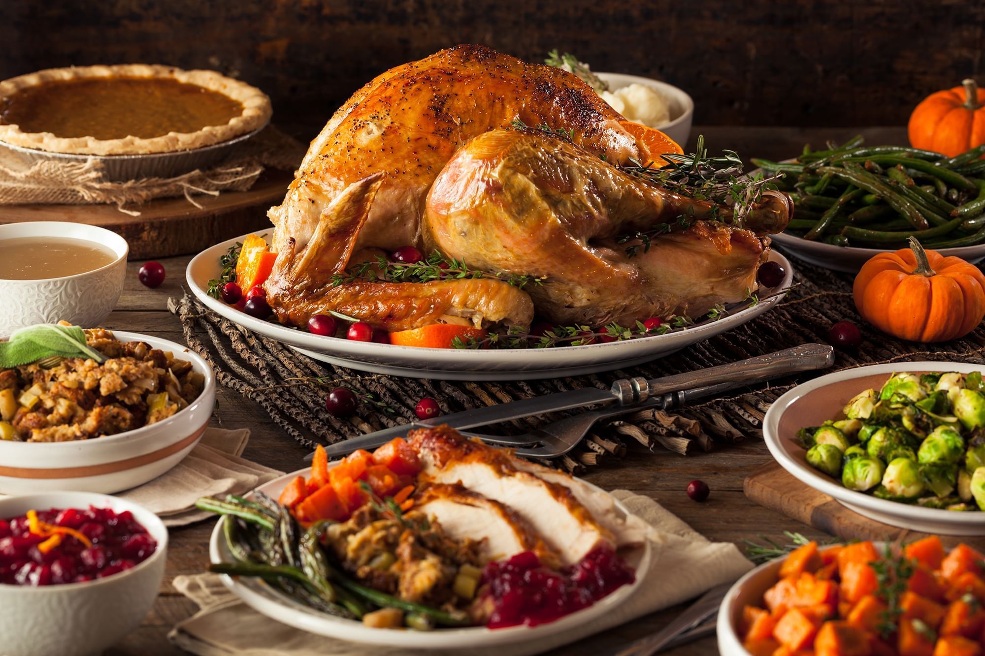 Elegant table setting with a grand Thanksgiving turkey, pumpkin pie, and fresh salad at the Peabody Hotel in Memphis