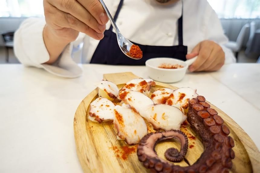 A chef preparing Polbo á feira food at Club Hemingway