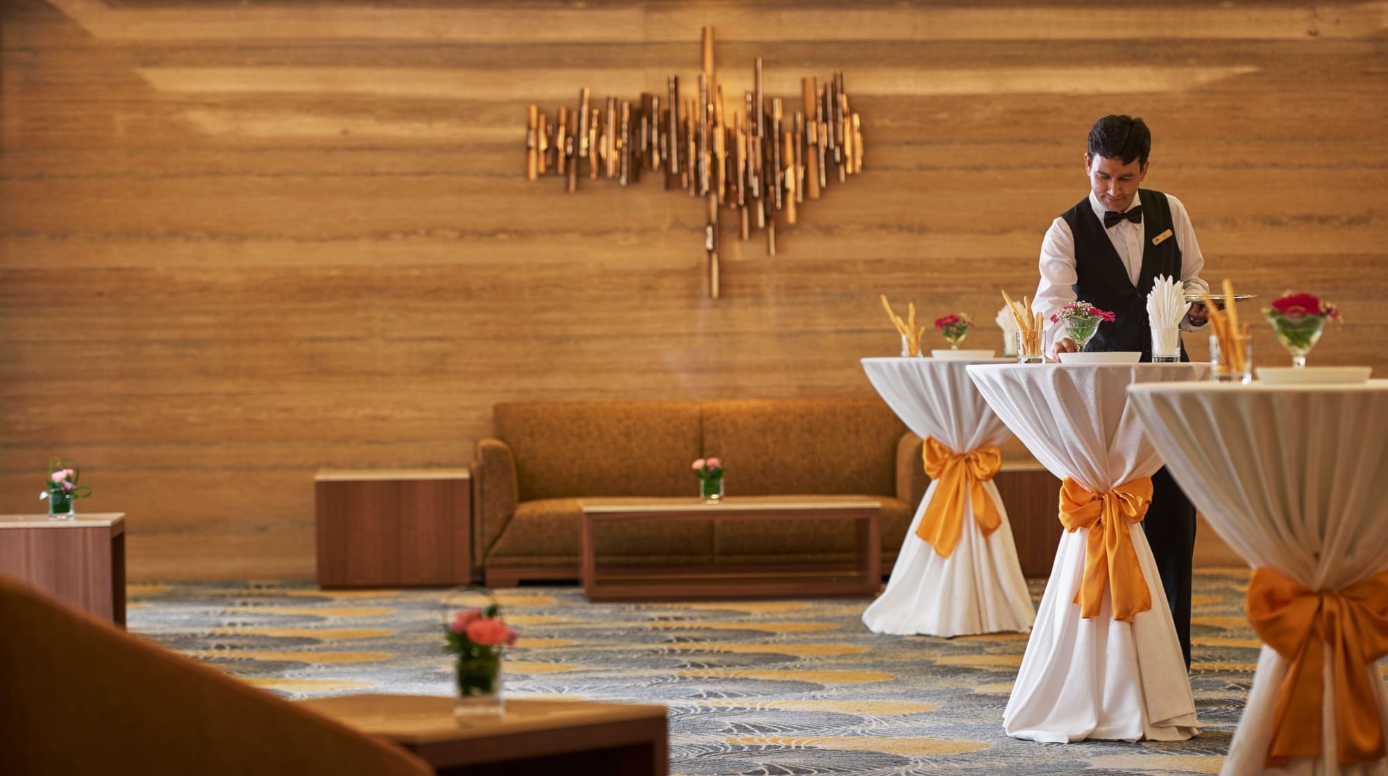 A waiter setting up for cocktail set-up at Sunway Putra Hotel