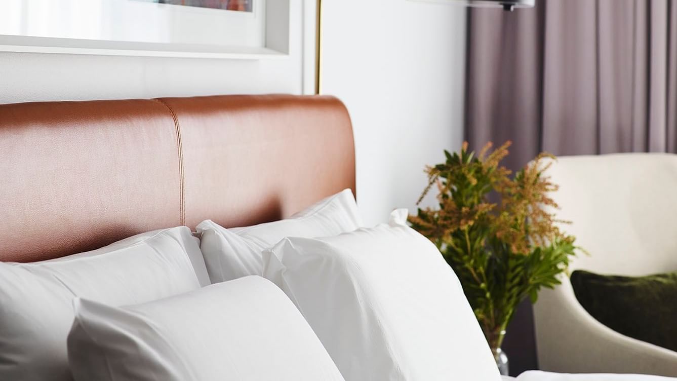 Comfy bed & lamp in a room at Novotel Sydney Darling Square
