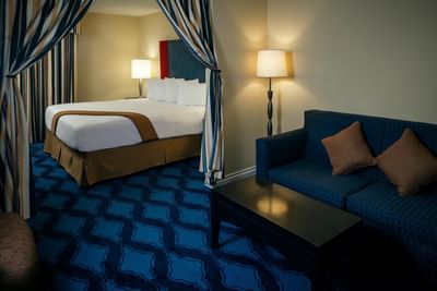 Spa King Creekview with a separate sitting area of Plaza Inn & Suites at Ashland Creek​