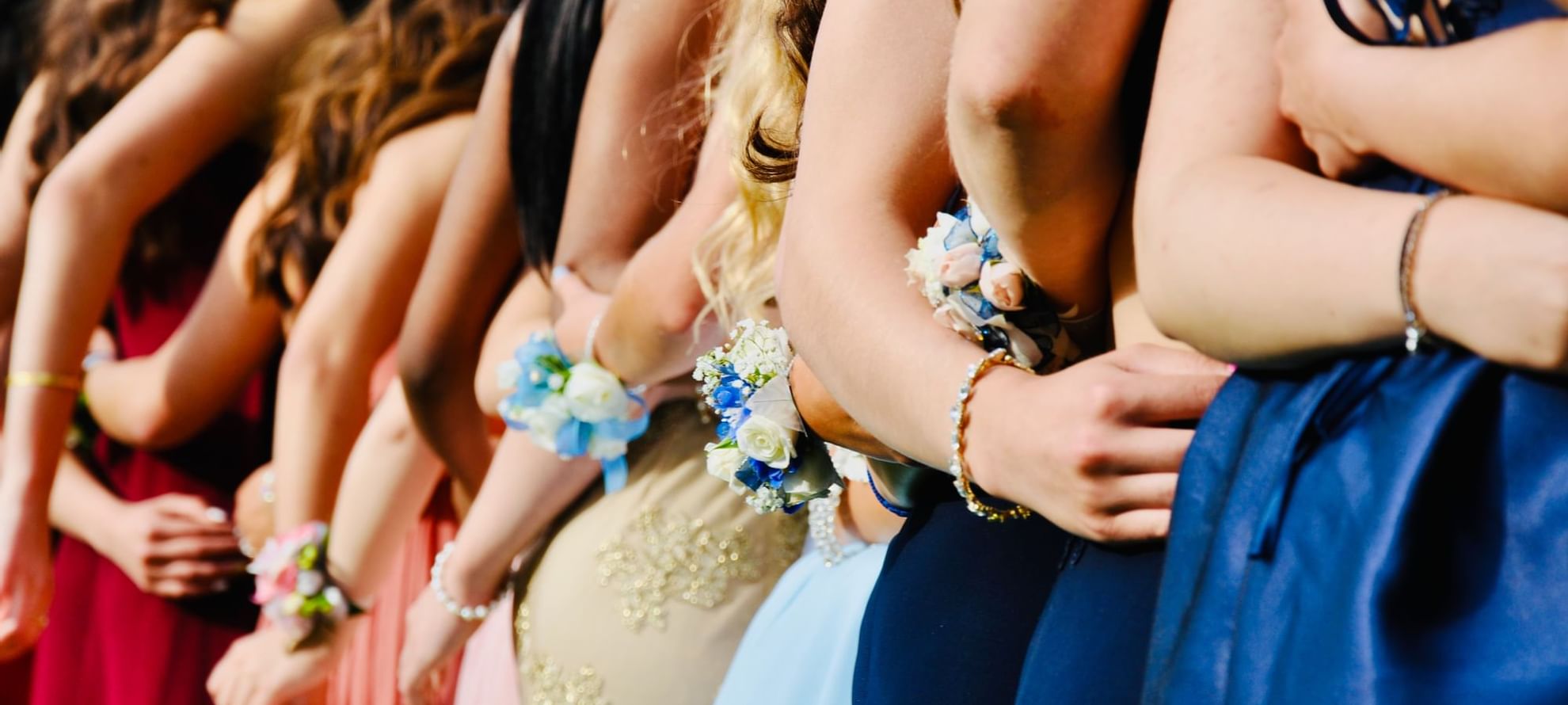 A group of girls in elegant wedding dresses posing together at Fullerton Sydney
