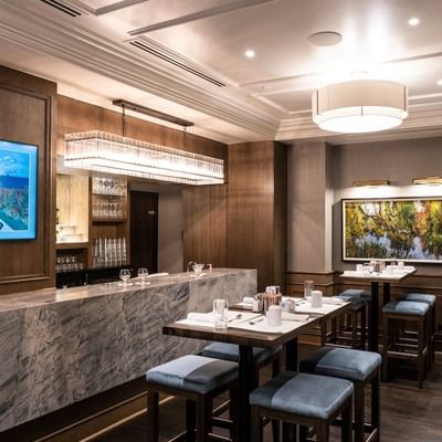 Bar counter & table set up in The Bar and Grill at The St. Regis Hotel Vancouver