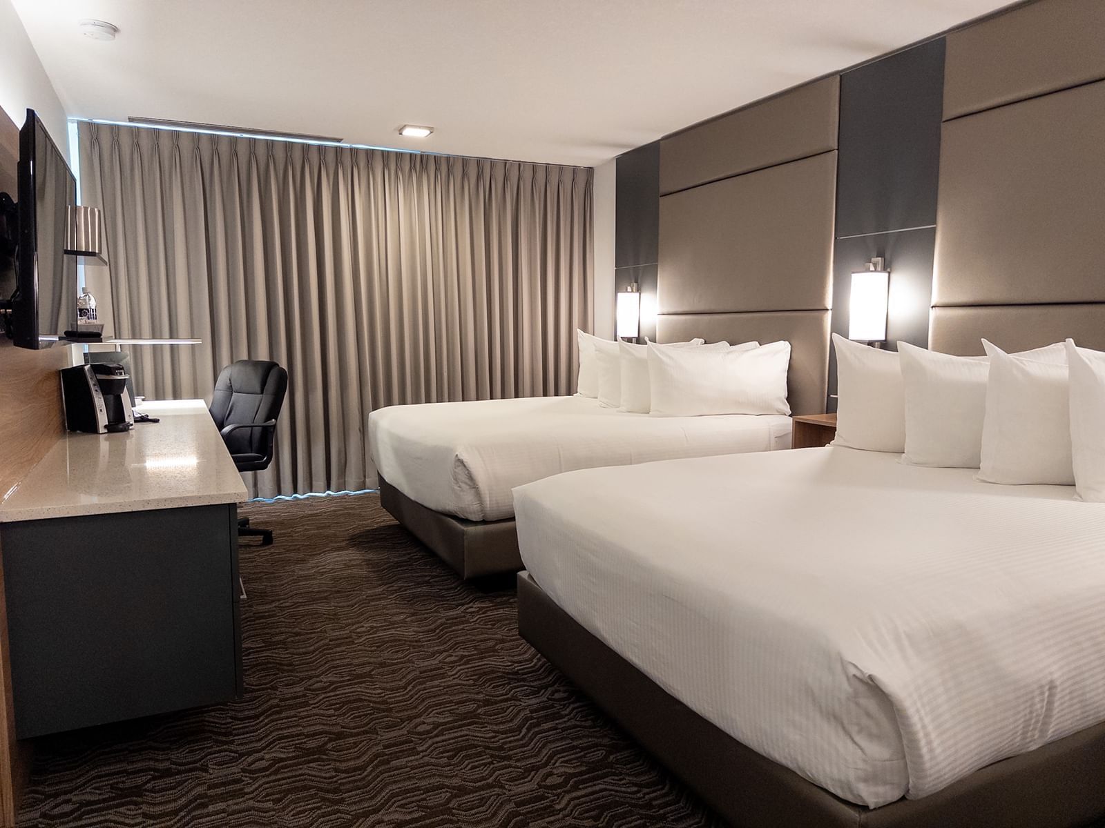 Premium 2 Queen room with two beds at Carriage House Hotel & Conference Centre in Calgary.
