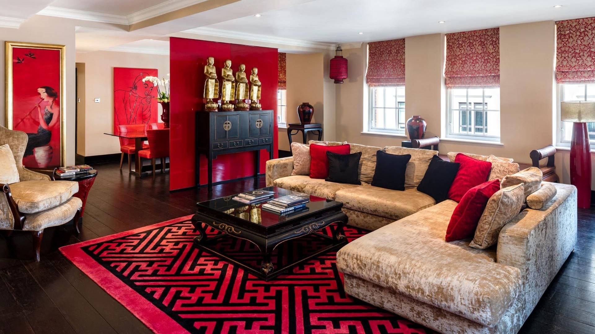 Luxurious living room in The Opium Suite at The May Fair Hotel London featuring sofas and an ornate red rug