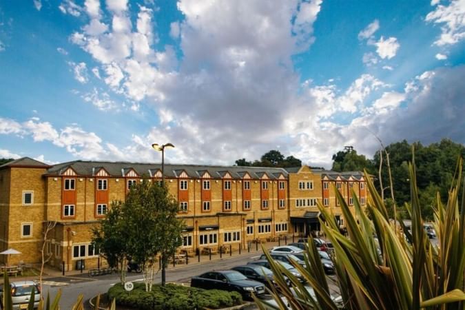 An exterior view of the hotel & car park at Village Hotels