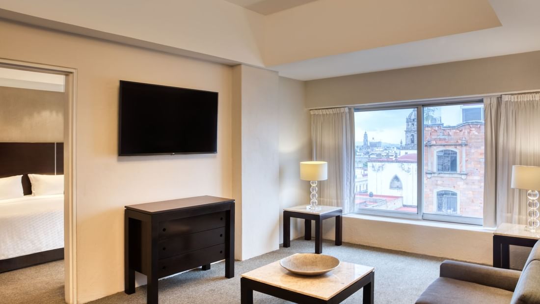 Living area with TV in Master King Suite at Gamma Hotels