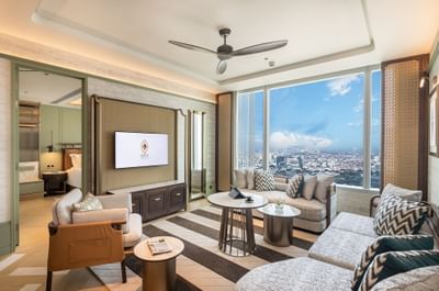 Comfy sofa, coffee tables & TV in a room at Eastin Grand Hotel Phayathai