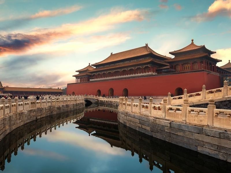 The Forbidden City in Beijing, with its red walls reflecting in the calm moat near Celebrity International Grand Hotel