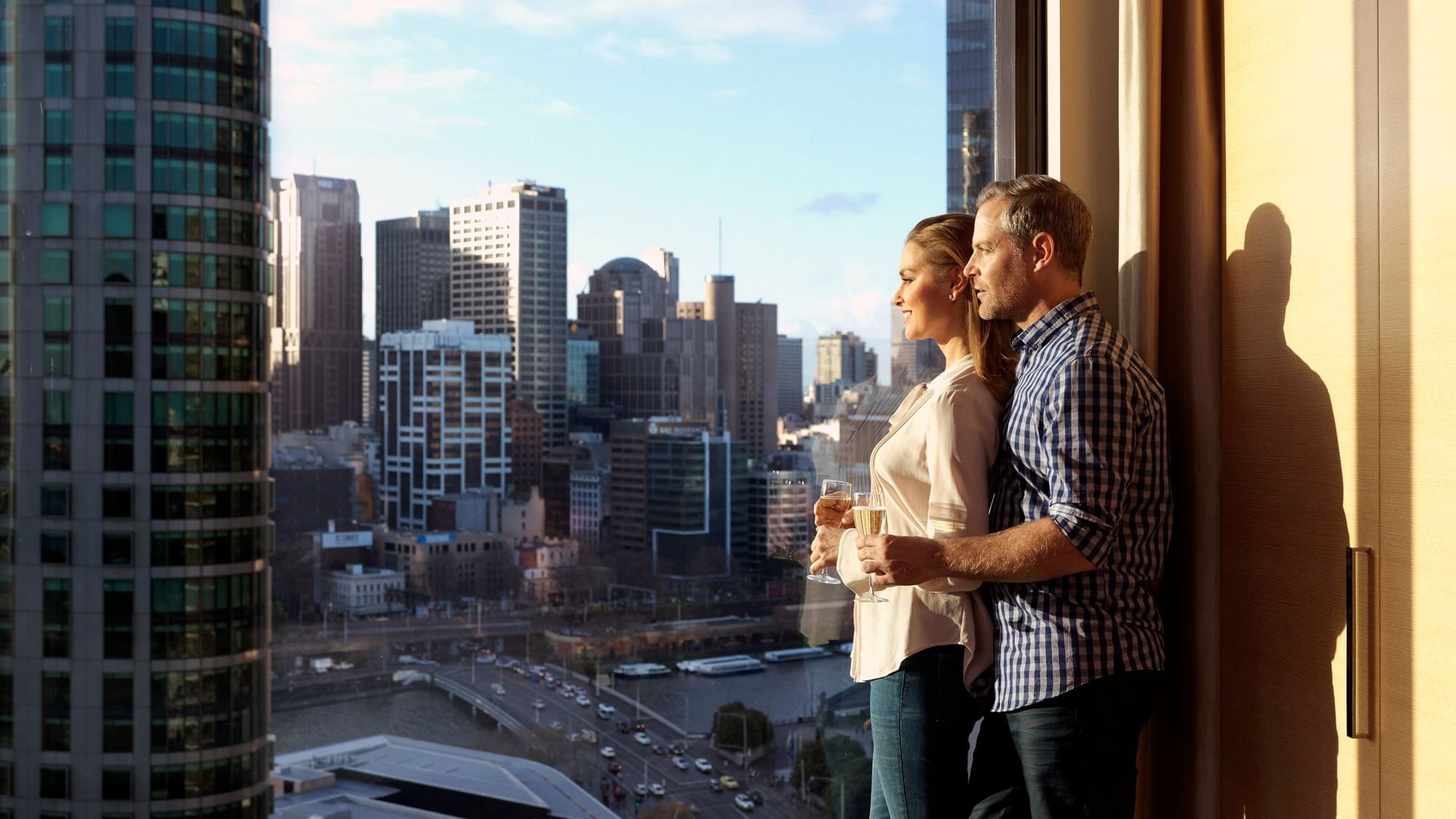 A Couple watching the sunset from Crown Promenade Melbourne