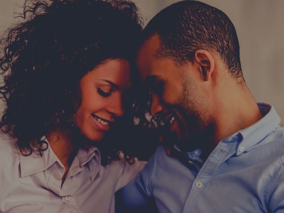 A couple embracing with smile faces at Amora Hotel