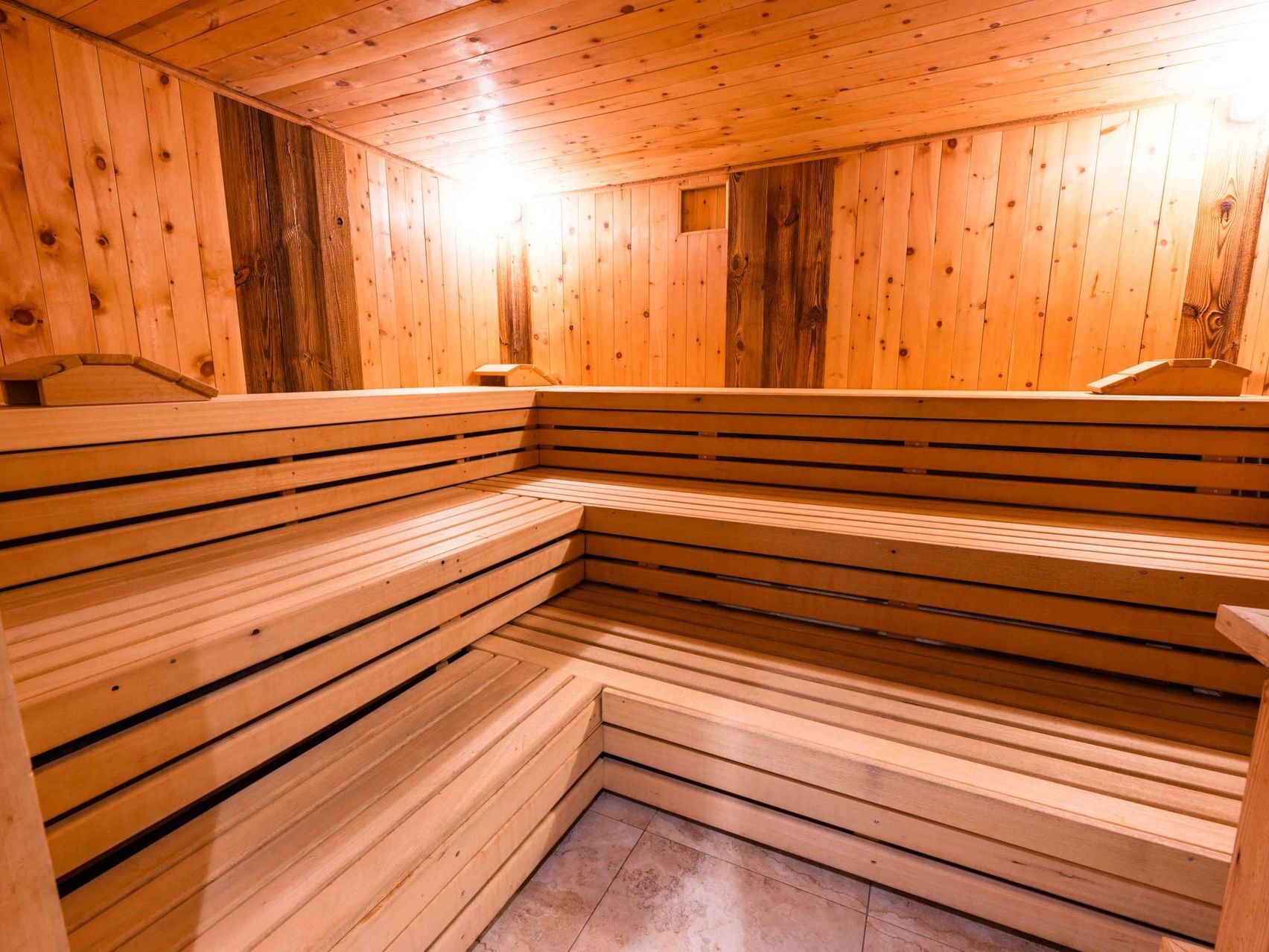 Wooden sauna with bench seating in the wellness area of Vitalhotel Gosau.