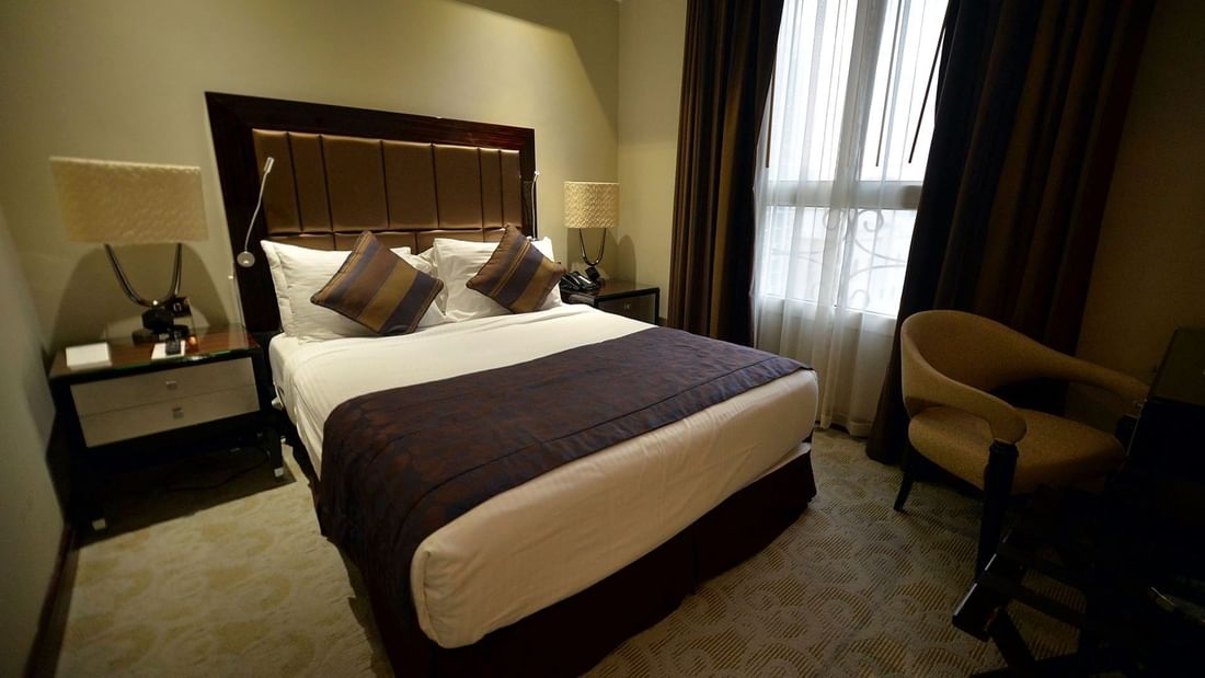 Bed with nightstand in Standard Queen Room at Strato Hotel by Warwick Doha