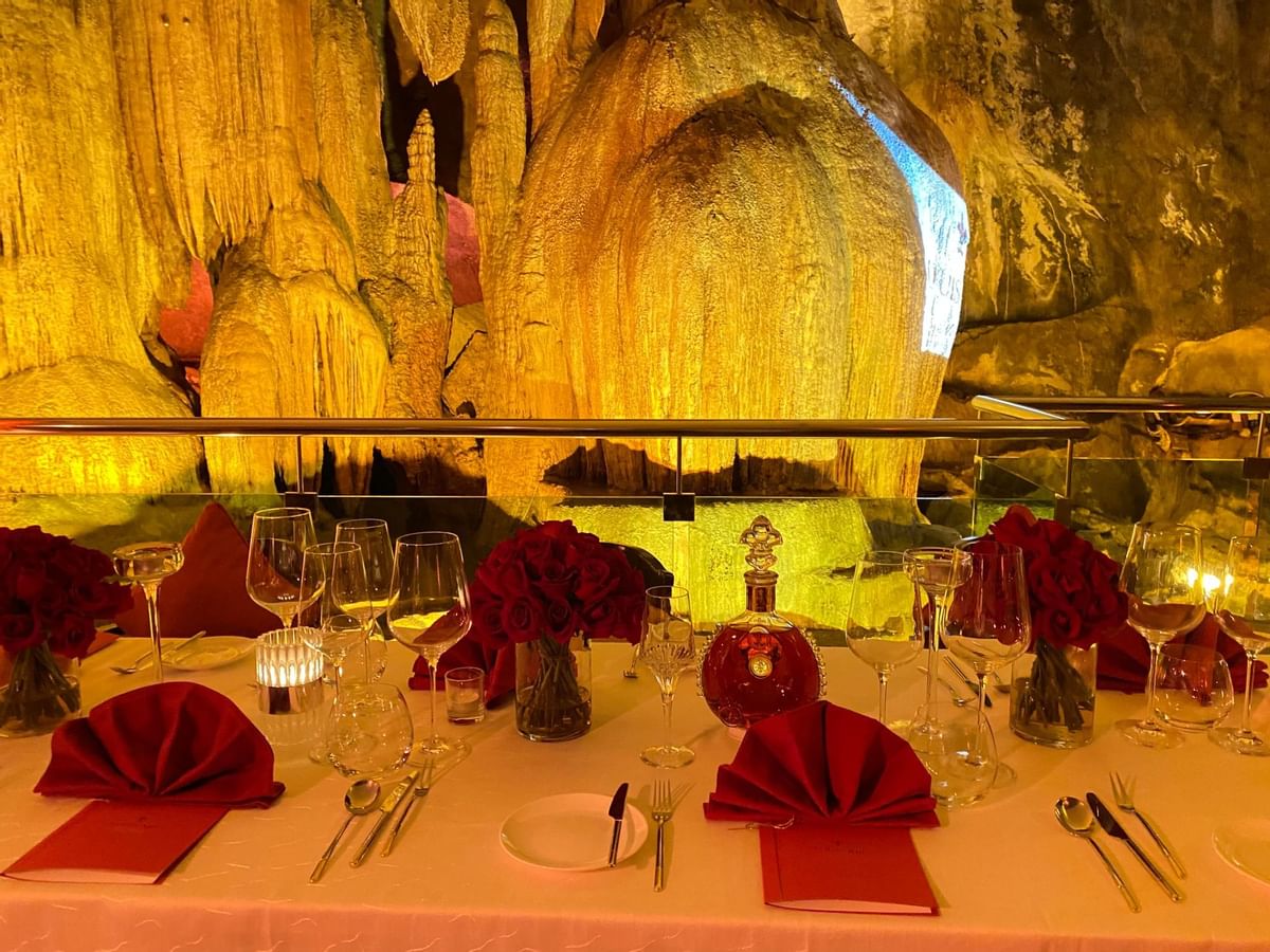 Close-up of roses & liquor beverages on a table served at The Banjaran Hotsprings Retreat
