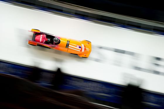 Person engaging bobsleigh at the Whistler Sliding Centre near Blackcomb Springs Suites