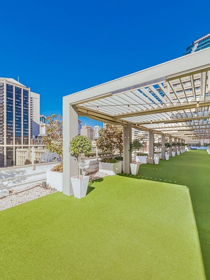 Rooftop garden with artificial grass and skyline view in Soiree Deck at Sofitel Brisbane Central