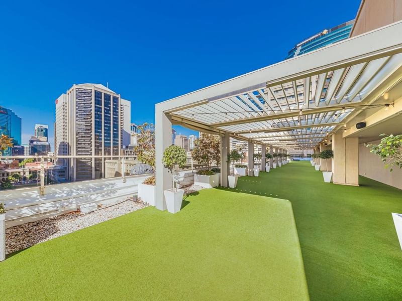 Rooftop garden with artificial grass and skyline view in Soiree Deck at Sofitel Brisbane Central