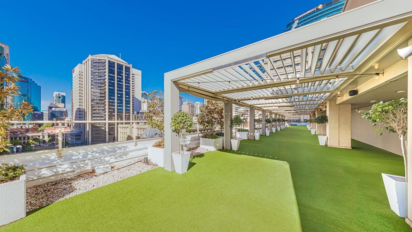 Rooftop garden with artificial grass and skyline view in Soiree Deck at Sofitel Brisbane Central