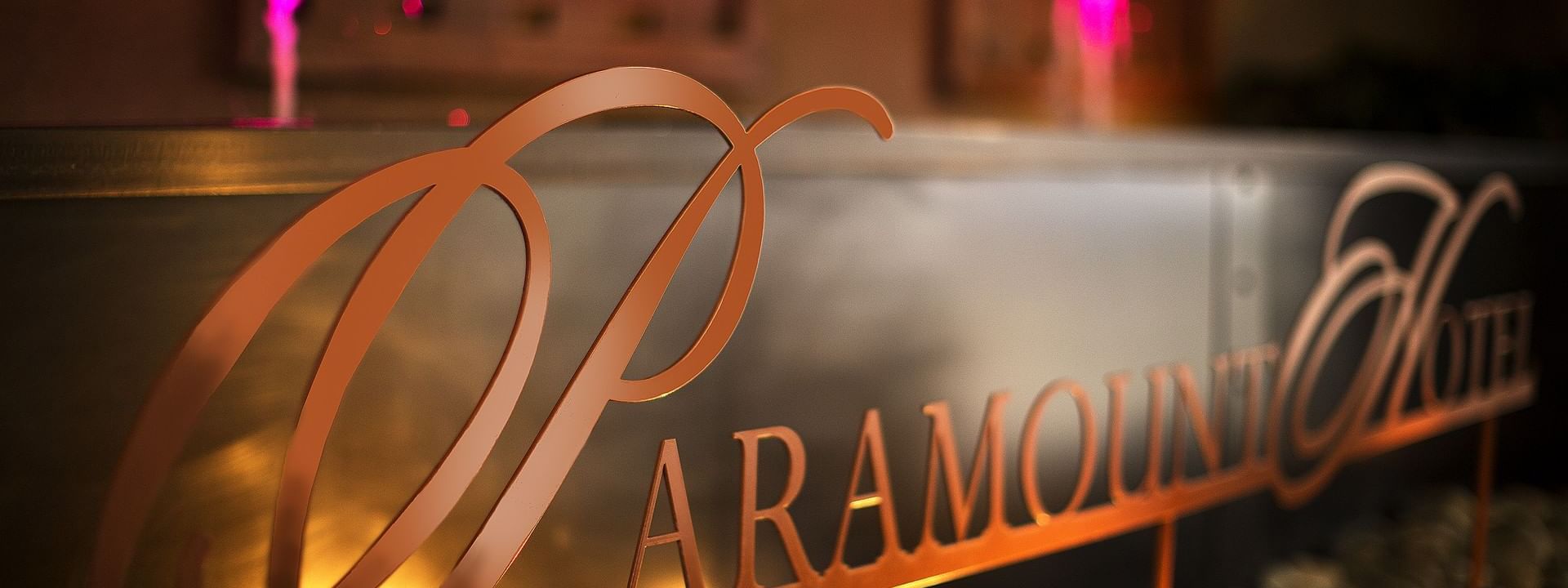 Illuminated Hotel sign by a water fountain at Paramount Hotel Seattle