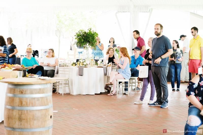 Guests mingling at a bright reception with white-draped tables at Aramark Chauncey Conference Center