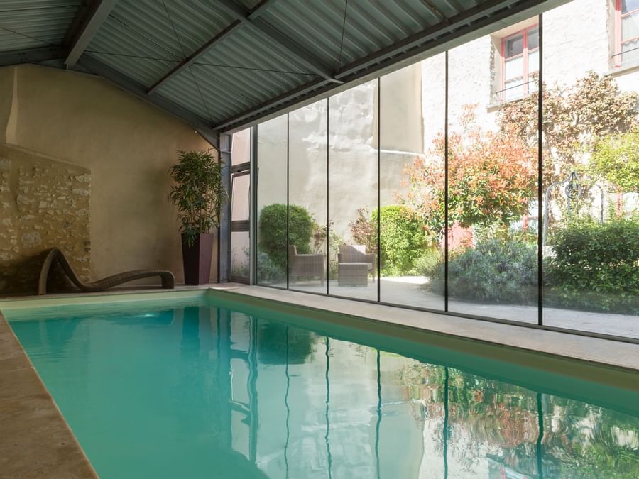 Indoor swimming pool at Hotel Aux Vieux Remparts