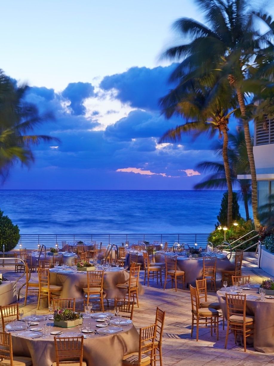 Outdoor dining area in a restaurant at Diplomat Beach Resort