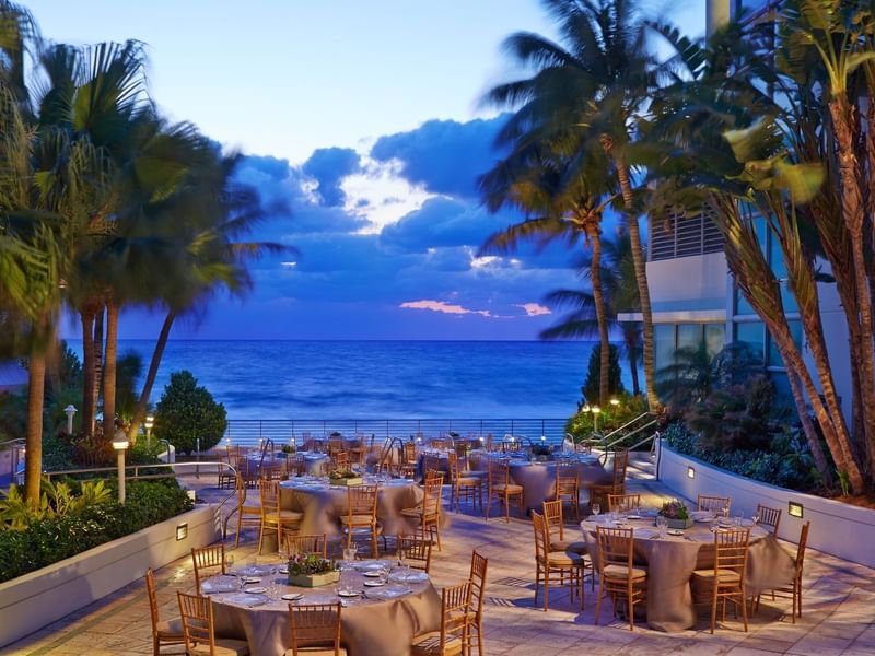 Outdoor dining area in a restaurant at Diplomat Beach Resort