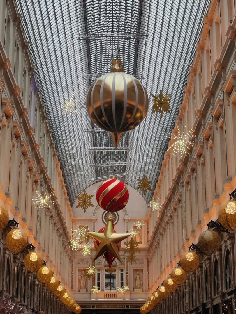 Festive ornaments and lights adorn a historic shopping arcade in Brussels at Warwick Brussels Grand-Place