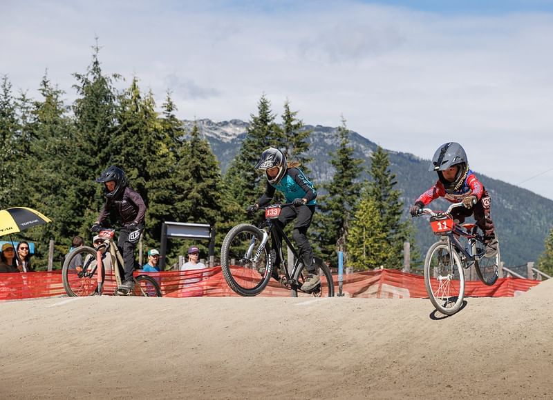 Bikers riding through sand in an event near Blackcomb Springs Suites