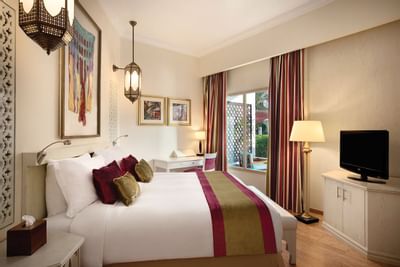 Double room with a double bad and TV screen at Ajman Hotel