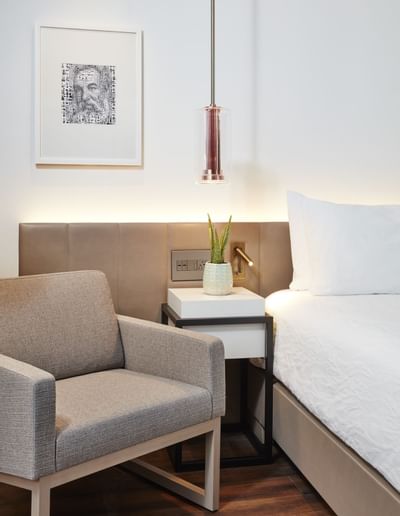 comfy chair next to a bed in a hotel room