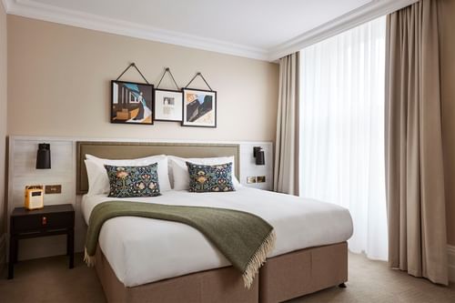 Double bed in Deluxe Room at The Clermont Victoria Hotel