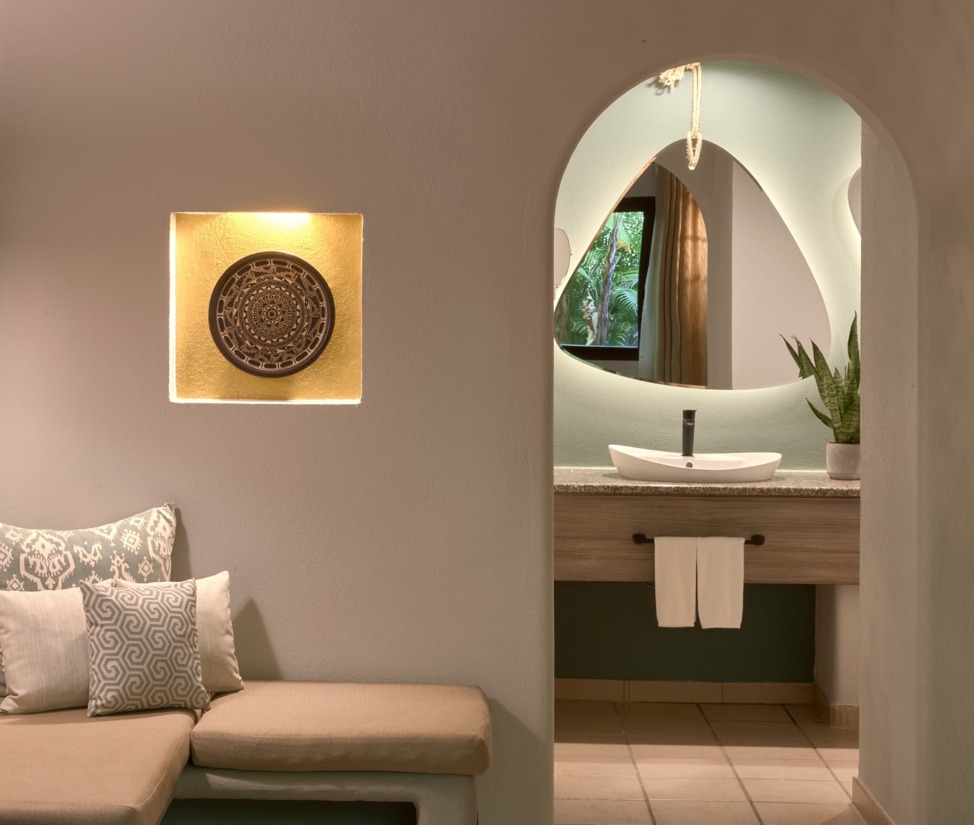 Secluded Deluxe Room 2 Queens with an organic shaped mirror and a decorative wall niche at Cala Luna Boutique Hotel
