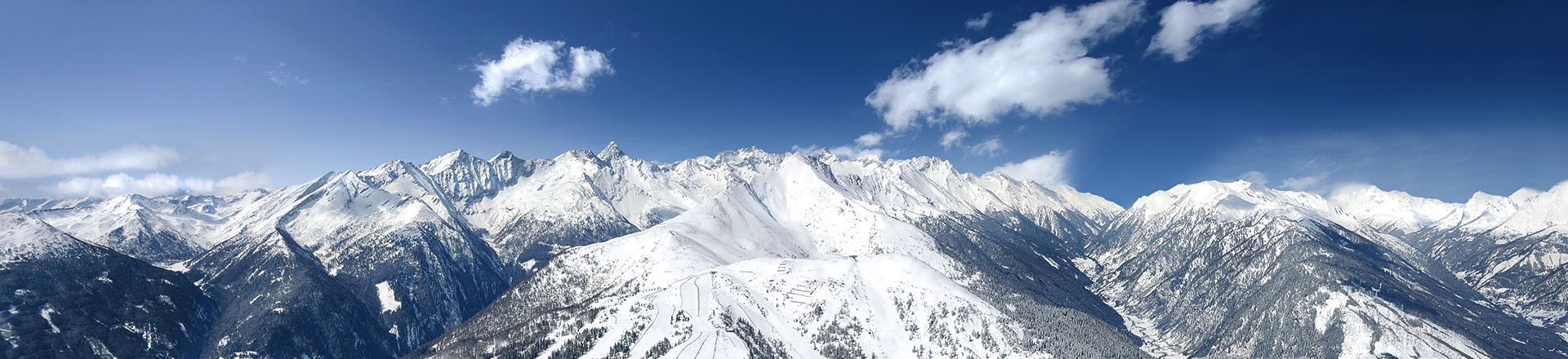 Aerial view of snowy hills & mountains, Falkensteiner Hotels