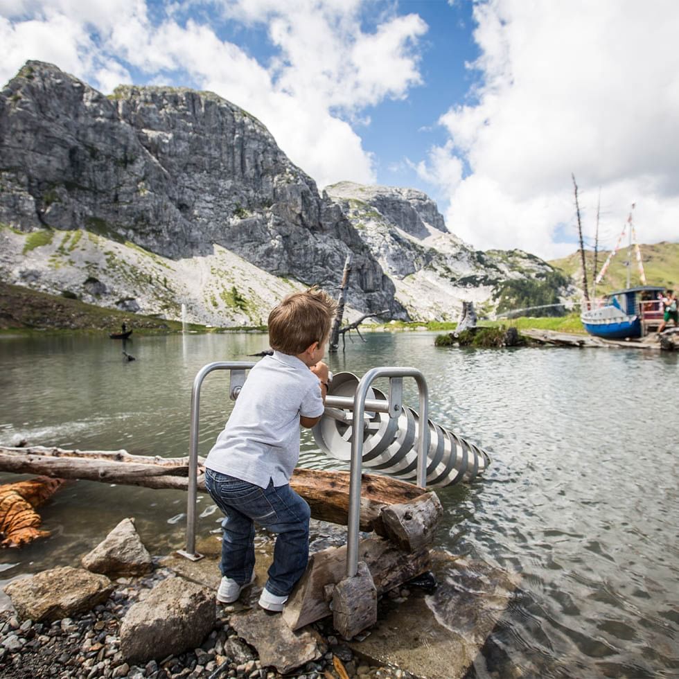 Child in Aqua Adventure Hiking Trail surrounded by rocky cliffs near Falkensteiner Hotel & Spa Carinzia