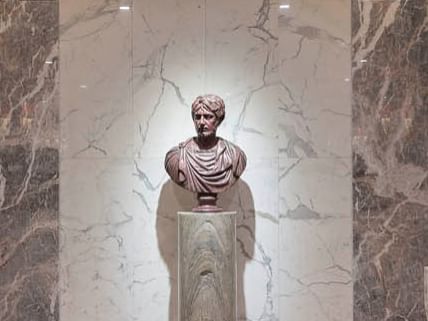 A marble bust of a man in a room with marble walls at Bettoja Hotels Group