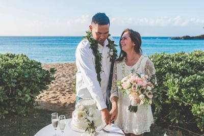 Wedded couple cutting a cake at Ka'anapali Beach Hotel Hawaii
