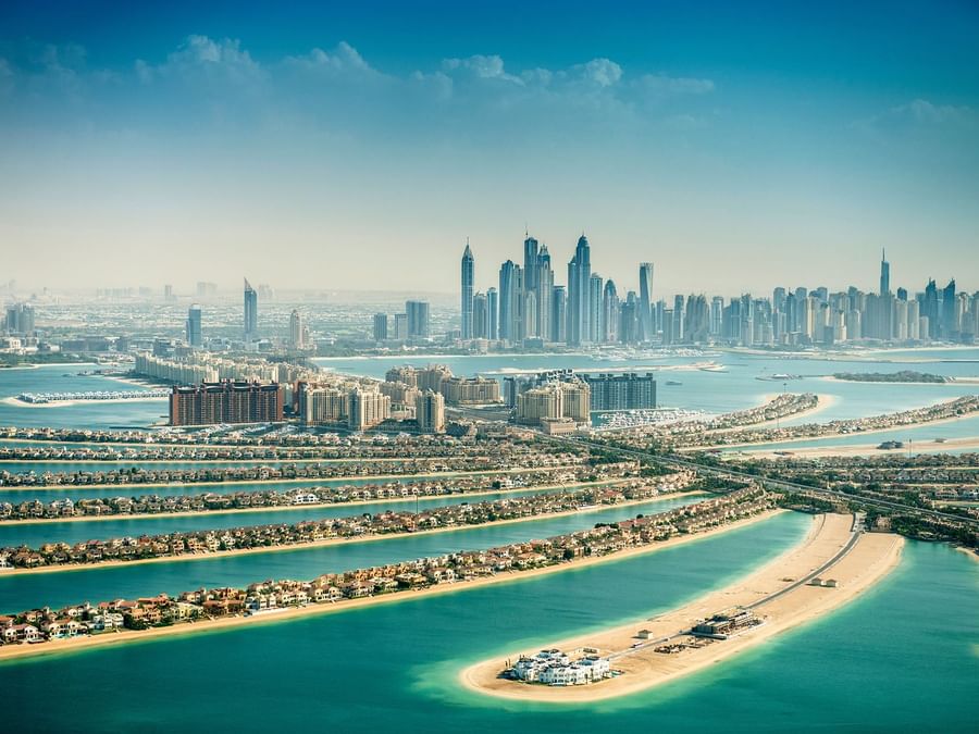 Aerial view of Dubai's coastline with skyscrapers and Palm Jumeirah near DAMAC Hotels & Resorts