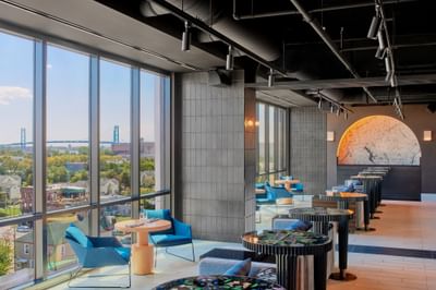 Lavish interior & decor with an outdoor view in IO Rooftop Lounge at Godfrey Hotel Detroit